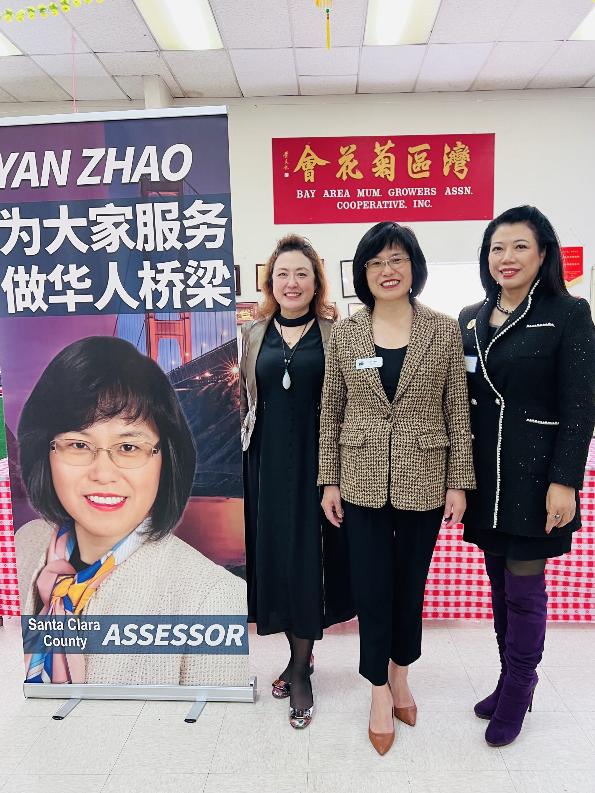 Yan standing with supporters at fundraiser